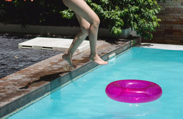 This image shows a woman jumping to the pool.